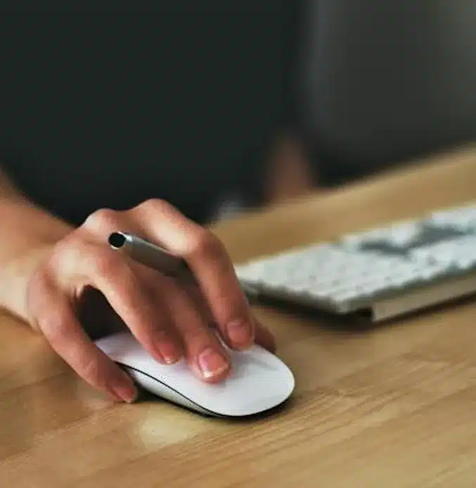 woman's hand on a computer mouse