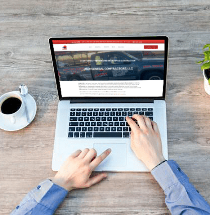 man typing on a laptop, working on a web page