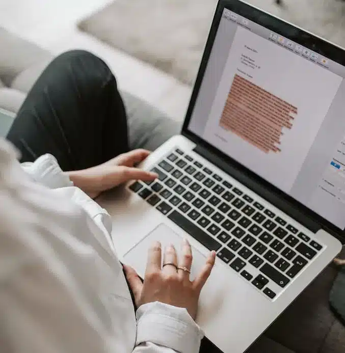 woman typing a blog on a laptop