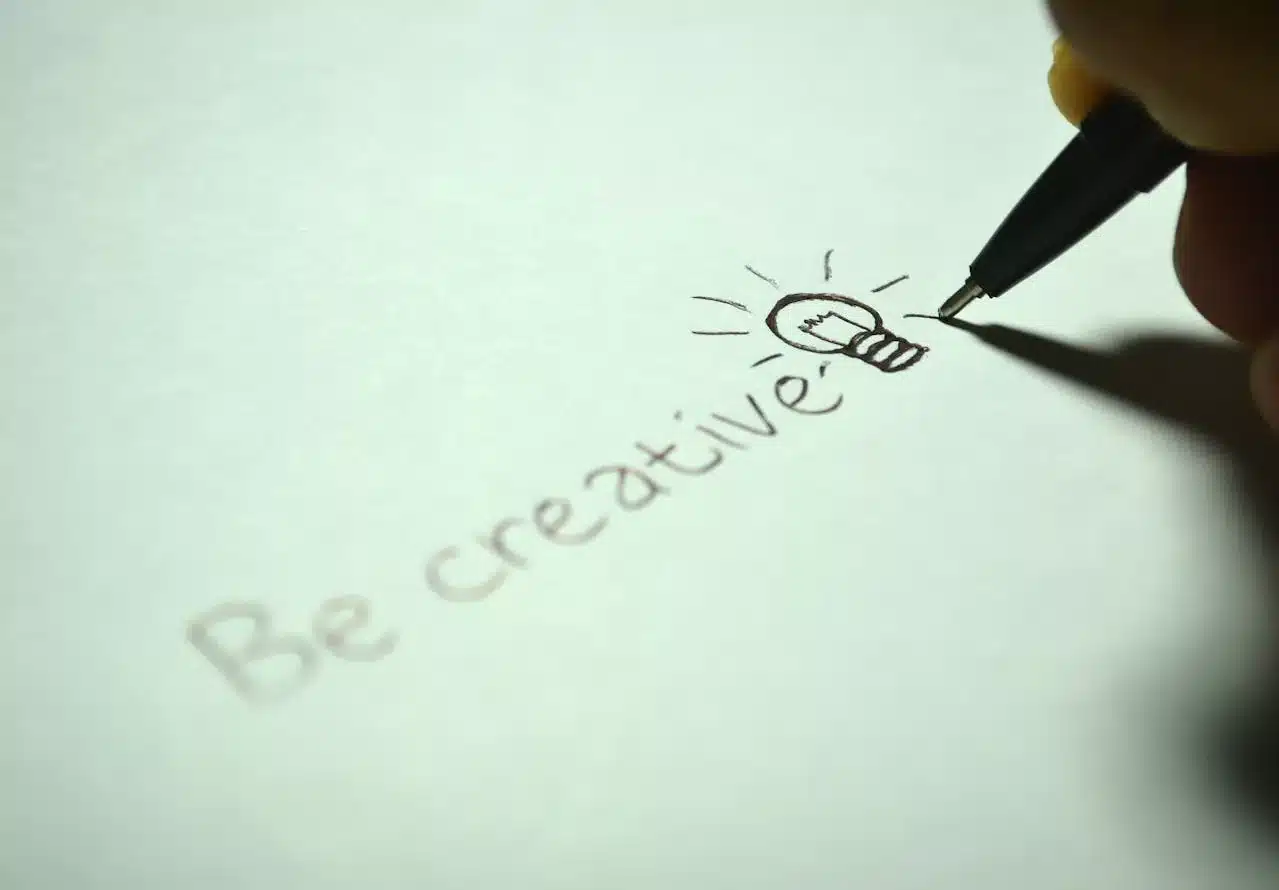 the text "be creative" written on a blank page