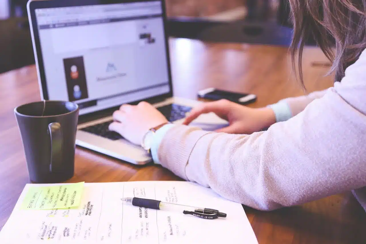 a woman typing on a laptop